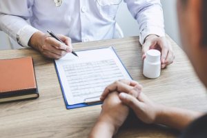 Healthcare practitioner prescribing medication to the patient