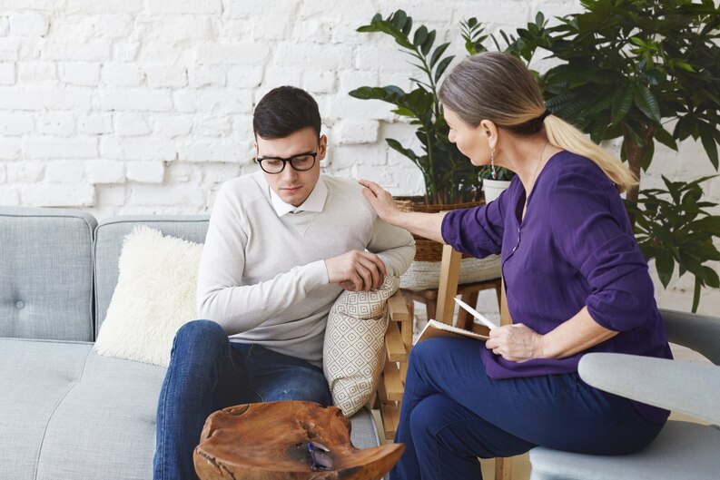 Therapist comforting the patient about their condition