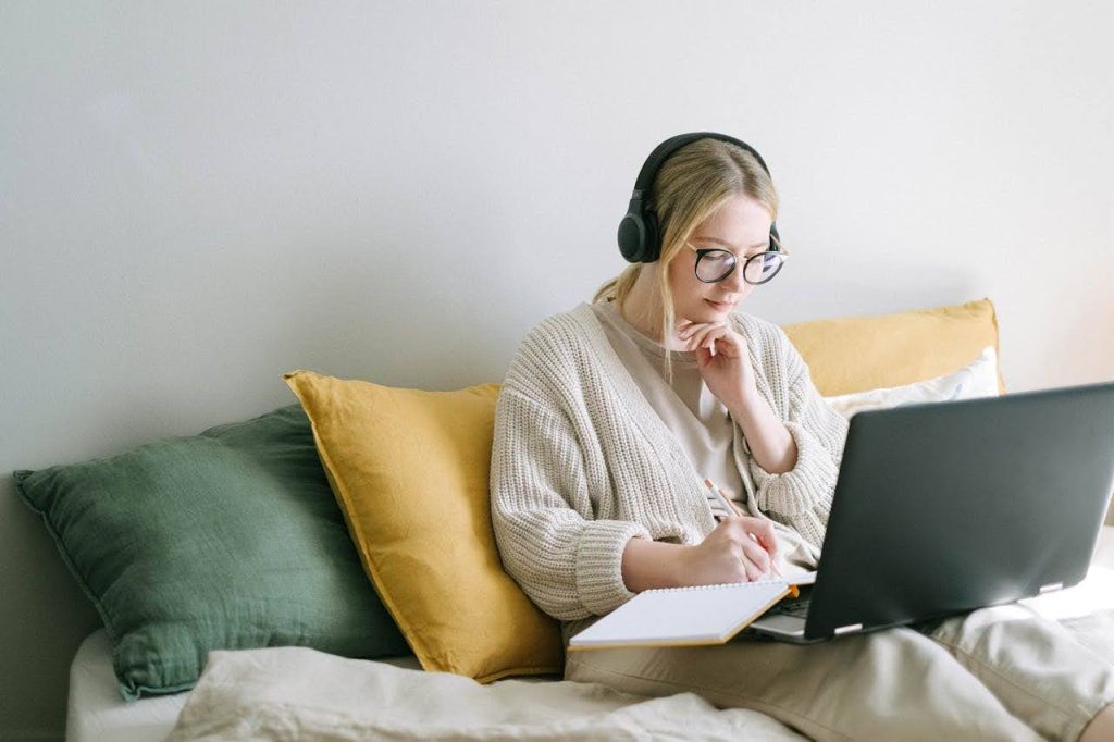 A young lady working on her online CBT Journal