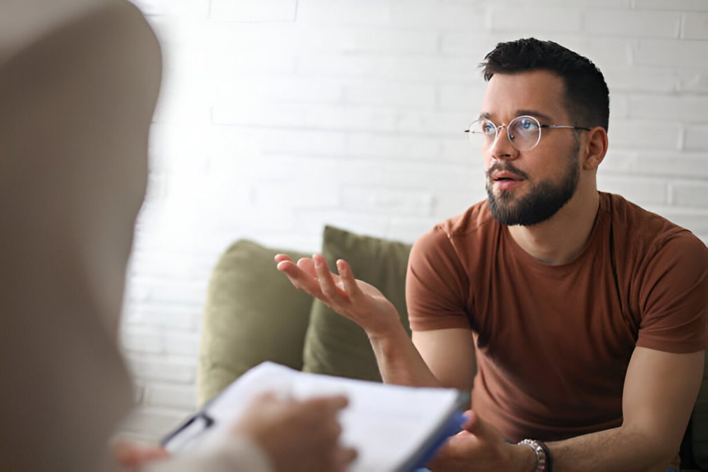 In-person counseling of a client dealing with PTSD in a psychotherapy clinic. 