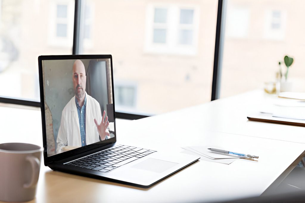 Therapist talking to a patient through video conference in an IOP